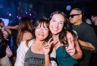 Guests smiling holding up peace sign at Time NightClub