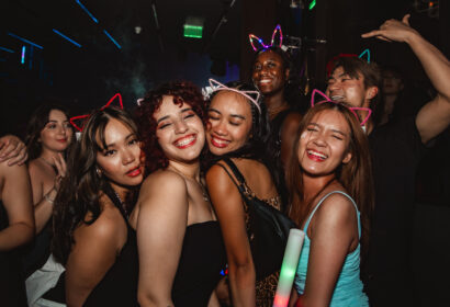 Guests posing with giveaways at Flashback at Time Nightclub