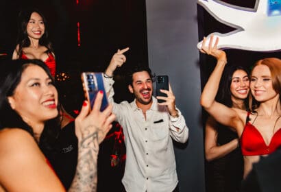 Guests posing at Henry Fong's Night Market at Time Nightclub in Costs Mesa, CA